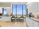 Bright kitchen with granite countertops, white cabinets, and ocean views at 1241 Gulf Of Mexico Dr # 708, Longboat Key, FL 34228