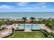 Resort-style pool with ocean view, lounge chairs, and a gazebo at 1241 Gulf Of Mexico Dr # 708, Longboat Key, FL 34228