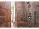 Luxurious shower with marble tile and modern fixtures at 1241 Gulf Of Mexico Dr # 708, Longboat Key, FL 34228