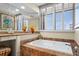 Relaxing bathroom with soaking tub, updated vanity, and large mirror at 1241 Gulf Of Mexico Dr # 708, Longboat Key, FL 34228