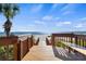Wooden walkway leading to a sandy beach at 1241 Gulf Of Mexico Dr # 708, Longboat Key, FL 34228