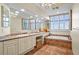 Elegant bathroom with double vanity, large soaking tub, and updated fixtures at 1241 Gulf Of Mexico Dr # 708, Longboat Key, FL 34228