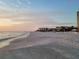 Scenic beach at sunset with condo buildings in background at 1241 Gulf Of Mexico Dr # 708, Longboat Key, FL 34228