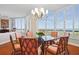 Bright dining room with bay window, chandelier and ocean view at 1241 Gulf Of Mexico Dr # 708, Longboat Key, FL 34228
