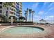 Circular spa with seating and nearby outdoor shower at 1241 Gulf Of Mexico Dr # 708, Longboat Key, FL 34228