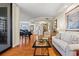 Spacious living area featuring hardwood floors, a piano, and access to a balcony at 1241 Gulf Of Mexico Dr # 708, Longboat Key, FL 34228
