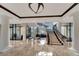Grand lobby with a sweeping staircase and marble floors at 1241 Gulf Of Mexico Dr # 708, Longboat Key, FL 34228