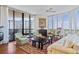 Living room with hardwood floors, large windows, and comfortable seating at 1241 Gulf Of Mexico Dr # 708, Longboat Key, FL 34228