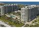 Oceanfront high-rise building with pool and lush landscaping at 1241 Gulf Of Mexico Dr # 708, Longboat Key, FL 34228