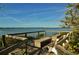 Enjoy water views from this relaxing waterfront deck with benches at 1703 Pelican Cove Rd # Gl457, Sarasota, FL 34231