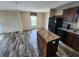 Kitchen with island, granite countertops, and dark wood cabinets at 705 50Th Avenue W Dr, Bradenton, FL 34207