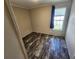 Simple bedroom with wood-look floors and a window at 705 50Th Avenue W Dr, Bradenton, FL 34207