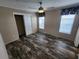 Bedroom with ceiling fan, closet and wood-look flooring at 705 50Th Avenue W Dr, Bradenton, FL 34207