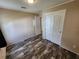 Bedroom with double door closet and wood-look floors at 705 50Th Avenue W Dr, Bradenton, FL 34207
