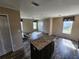 Open concept kitchen and living area with wood-look flooring at 705 50Th Avenue W Dr, Bradenton, FL 34207