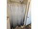 Shower stall with a clear shower curtain and grab bar at 705 50Th Avenue W Dr, Bradenton, FL 34207