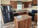 Modern kitchen with granite countertops and island at 705 50Th Avenue W Dr, Bradenton, FL 34207