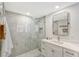 Modern bathroom with a glass shower, white vanity, and a large mirror at 3442 Fairview Dr, Sarasota, FL 34239