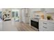 Modern kitchen with white cabinets, stainless steel appliances and a large island at 3442 Fairview Dr, Sarasota, FL 34239