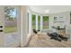 Sunlit home office features hardwood floors, a view of the backyard, and a cowhide rug at 3442 Fairview Dr, Sarasota, FL 34239
