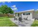 Backyard patio with seating area and lush green lawn at 3442 Fairview Dr, Sarasota, FL 34239