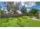 Expansive backyard with grassy lawn and wooden fence at 3442 Fairview Dr, Sarasota, FL 34239