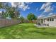 Fenced backyard with grassy lawn and patio at 3442 Fairview Dr, Sarasota, FL 34239