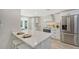 Modern kitchen with white cabinets, stainless steel appliances & breakfast bar at 3442 Fairview Dr, Sarasota, FL 34239