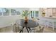 Bright dining area with an oval table and access to the backyard at 3442 Fairview Dr, Sarasota, FL 34239