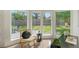 Home office with large windows, hardwood floors, and a view of the backyard at 3442 Fairview Dr, Sarasota, FL 34239