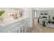 Bright kitchen with white cabinets, quartz countertops, and an open layout to the living area at 3442 Fairview Dr, Sarasota, FL 34239