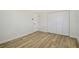 Bright bedroom featuring wood-look flooring and white doors at 3442 Fairview Dr, Sarasota, FL 34239