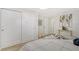 Spacious bedroom with white closet doors and neutral decor at 3442 Fairview Dr, Sarasota, FL 34239