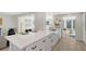 Open concept kitchen with white cabinets, stainless steel appliances, and quartz countertops at 3442 Fairview Dr, Sarasota, FL 34239