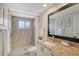 Updated bathroom with a shower/tub combo and granite countertop at 3442 Fairview Dr, Sarasota, FL 34239