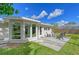 Backyard with patio, seating area, and large windows at 3442 Fairview Dr, Sarasota, FL 34239