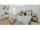 Bright bedroom with a neutral color palette, wicker nightstands, and a large bed at 3442 Fairview Dr, Sarasota, FL 34239
