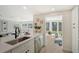 Modern kitchen features white cabinets, stainless steel appliances, and a sunlit breakfast nook at 3442 Fairview Dr, Sarasota, FL 34239