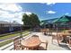 Outdoor patio area with tables, umbrellas, and a mural backdrop at 3442 Fairview Dr, Sarasota, FL 34239