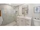 Clean bathroom with a walk-in shower, white vanity, and modern fixtures at 3442 Fairview Dr, Sarasota, FL 34239