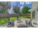 Relaxing backyard patio with seating area and lush lawn at 3442 Fairview Dr, Sarasota, FL 34239