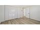 Well-lit bedroom with white closet doors and wood-look floors at 3442 Fairview Dr, Sarasota, FL 34239