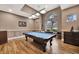 Game room features a pool table, hardwood floors, and large windows at 10444 48Th E Ct, Parrish, FL 34219