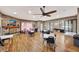 Community room with fireplace, tables, chairs, and a view into the game room at 10444 48Th E Ct, Parrish, FL 34219