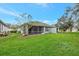 Landscaped backyard with screened porch at 10444 48Th E Ct, Parrish, FL 34219