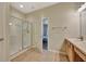 Modern bathroom with a glass-enclosed shower and light wood vanity at 10444 48Th E Ct, Parrish, FL 34219