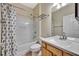 Bathroom featuring tub with shower, white vanity, neutral walls, and decorative shower curtain at 10444 48Th E Ct, Parrish, FL 34219