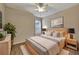 Tastefully decorated bedroom with wood-look floors, neutral walls, ceiling fan, and natural light at 10444 48Th E Ct, Parrish, FL 34219