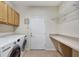 Functional laundry room with washer, dryer, storage cabinets, and countertop at 10444 48Th E Ct, Parrish, FL 34219