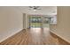 Bright and spacious living room with hardwood floors and sliding glass doors to the outdoors at 10444 48Th E Ct, Parrish, FL 34219